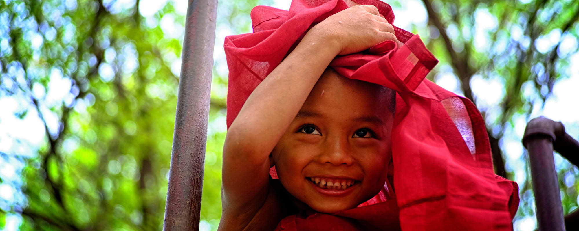 boy holding textile over his head